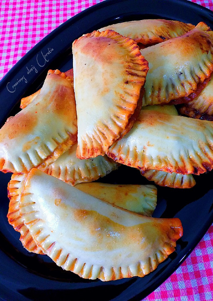 Una foto de Empanadillas de gambas en crema reducida de las mismas cabezas