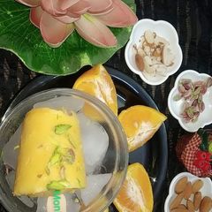 A picture of Orange flavour dry fruit kulfi.