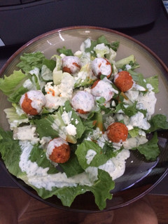A picture of Crispy Buffalo Quinoa Bites Salad with Cheesy Ranch.