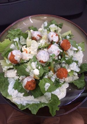 A picture of Crispy Buffalo Quinoa Bites Salad with Cheesy Ranch.