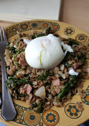 A picture of Warm lentil, bacon and kale salad with poached egg.