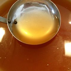 A picture of Golden Consommé Soup with Vegetable Off-Cuts.