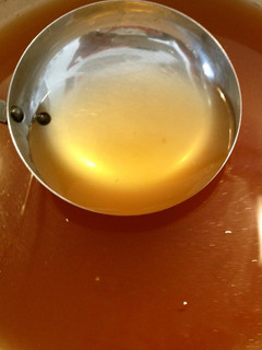 A picture of Golden Consommé Soup with Vegetable Off-Cuts.