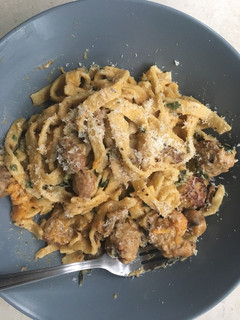 A picture of Homemade tagliatelle with pork meatballs and in a creamy sauce.