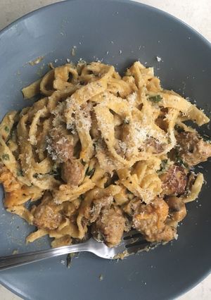 A picture of Homemade tagliatelle with pork meatballs and in a creamy sauce.