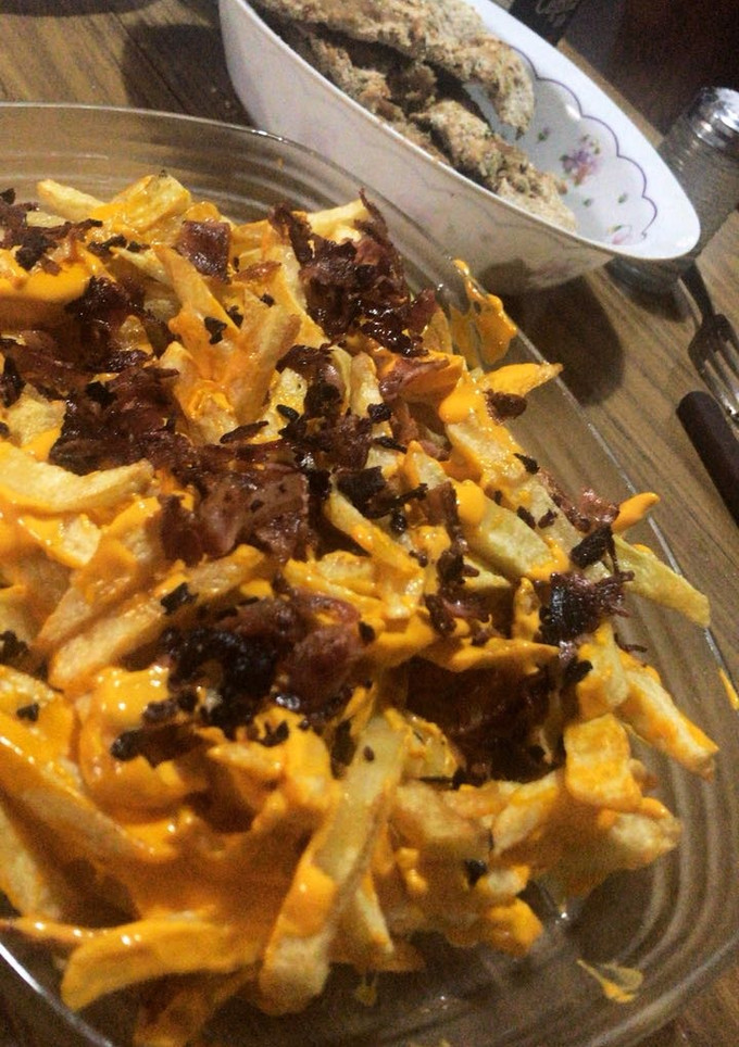 Una foto de Papas con cheddar y bacon