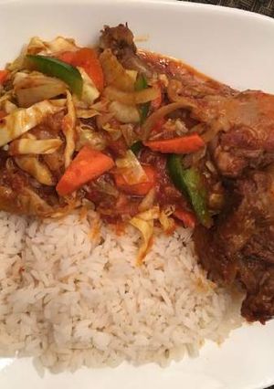 A picture of Ofada rice with chicken and vegetables.