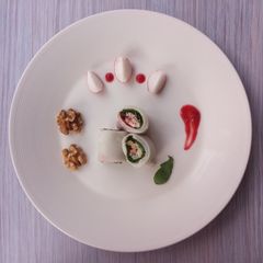 A picture of Ricerolls with blue cheese, arugula, and plum tomato sauce.