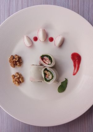 A picture of Ricerolls with blue cheese, arugula, and plum tomato sauce.