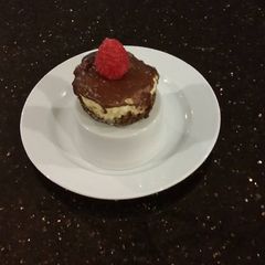 A picture of Individual Vanilla Cheesecakes with Chocolate Ganach Topping.