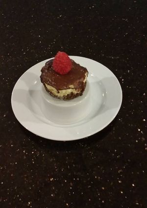 A picture of Individual Vanilla Cheesecakes with Chocolate Ganach Topping.