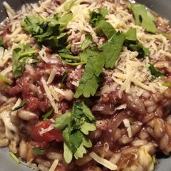A picture of Red risotto with chorizo (or fake bacon).