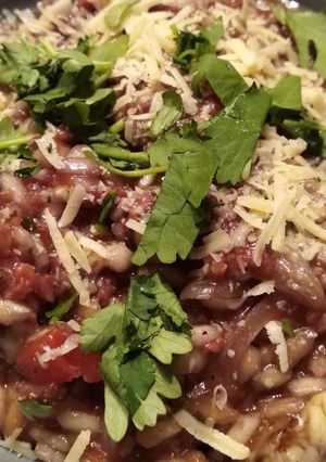 A picture of Red risotto with chorizo (or fake bacon).