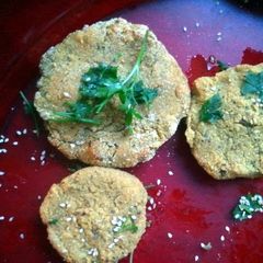 A picture of soy burger with vegetables sesame and parsley..