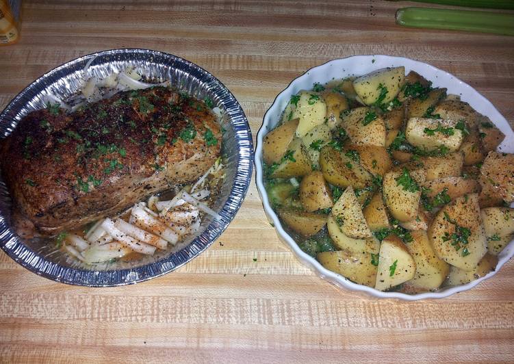 pork roast tenderloin with roasted potatoes and corn on the cob