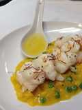 Lobster poached in vanilla bean butter served with saffron, sweet pea risotto