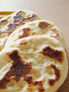 A picture of Light and Puffy Homemade Naan Bread in a Pan.