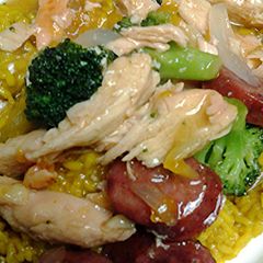 A picture of chicken and sausage in duck sauce.