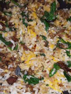 A picture of Sausage, spinach, and rice.