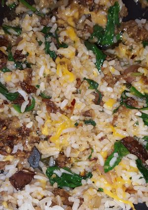 A picture of Sausage, spinach, and rice.