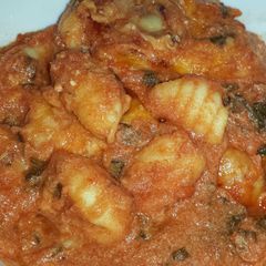 A picture of baked gnocchi with spinach and ricotta.