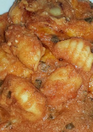 A picture of baked gnocchi with spinach and ricotta.