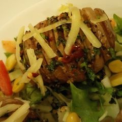 A picture of Hasselback Potatoes Served with garden fresh salad.