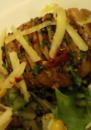 A picture of Hasselback Potatoes Served with garden fresh salad.
