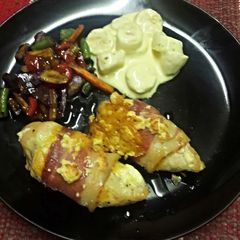 A picture of Chicken Fillet Wrapped in Bacon, Smothered in Cheese.