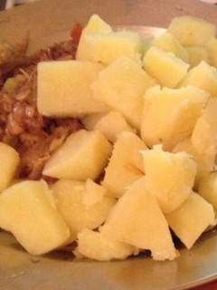 A picture of Boiled sweet potatoes served with stewed cabbage.