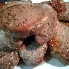 A picture of pork loin in a pan.