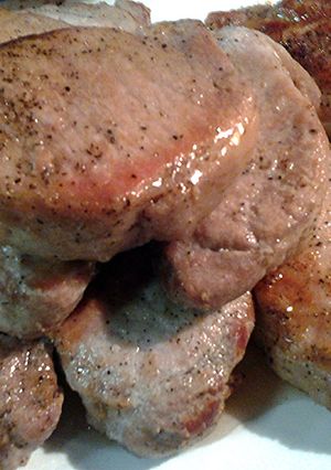 A picture of pork loin in a pan.