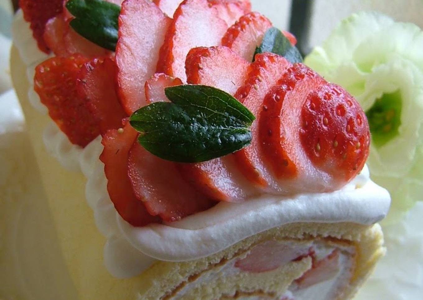 Roll cake with fresh strawberry cream
