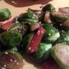 A picture of Brussels Sprouts sauteed with garlic and red bell pepper.