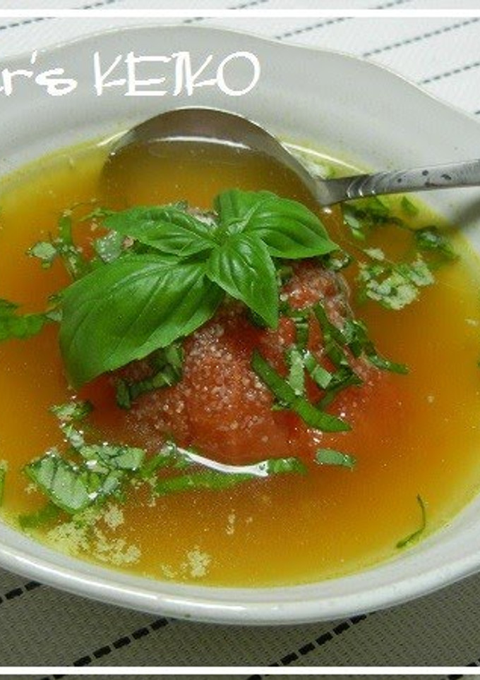A picture of Soup with A Soft Whole Tomato.