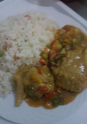 A picture of White rice with chicken sauce.