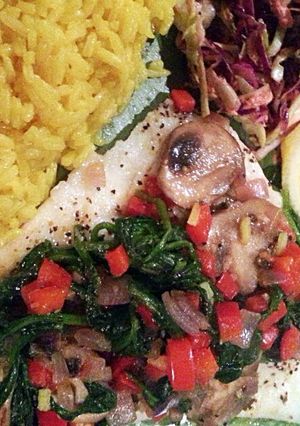 A picture of Baked Cod with a vegetable sautee topping.
