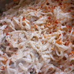 A picture of Chicken mushroom noodles in white sauce.