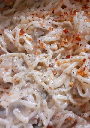 A picture of Chicken mushroom noodles in white sauce.