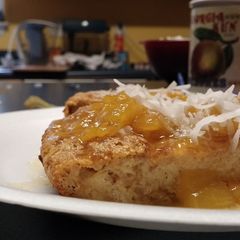 A picture of Coconut Bread Pudding with Mango sauce.