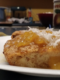 A picture of Coconut Bread Pudding with Mango sauce.