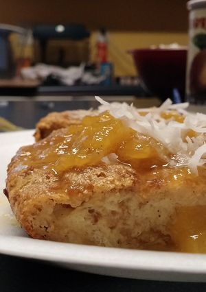 A picture of Coconut Bread Pudding with Mango sauce.