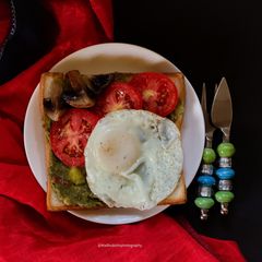 A picture of Poach on Avocado, mushrooms and tomato.
