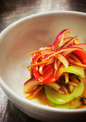 A picture of Marinated Cucumbers,Tomatoes and Red Onions in House Dressing.ti.