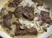 A picture of steak with mushroom sauce