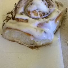 A picture of Professional cinnamon rolls topped with cream cheese icing.