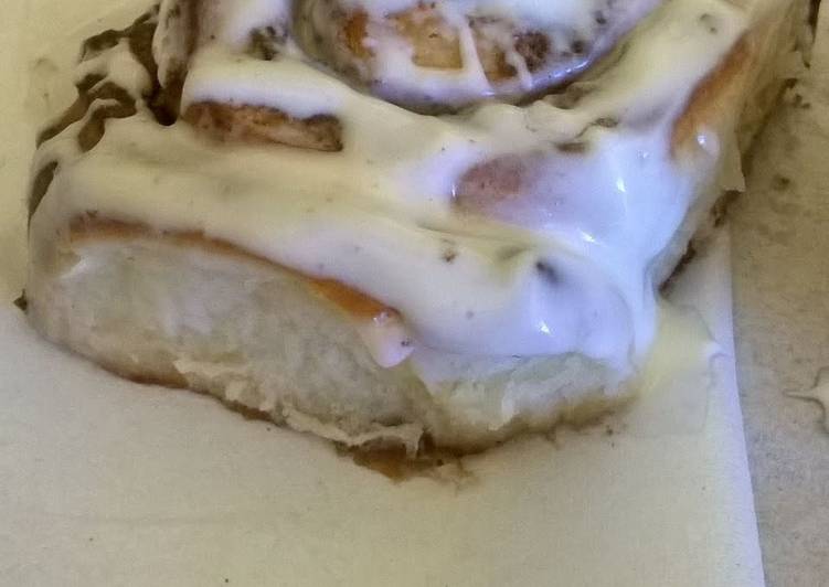 Professional cinnamon rolls topped with cream cheese icing