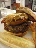 Beef Tender loin burger with pulled pork stuffed onion ring and melted cheddar cheese