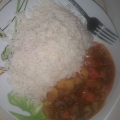 A picture of White rice and hearty beef stew.