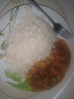 A picture of White rice and hearty beef stew.